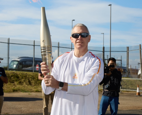 Former Paralympic Gold medallist Ian Rose with the 2024 Paralympic Games Torch