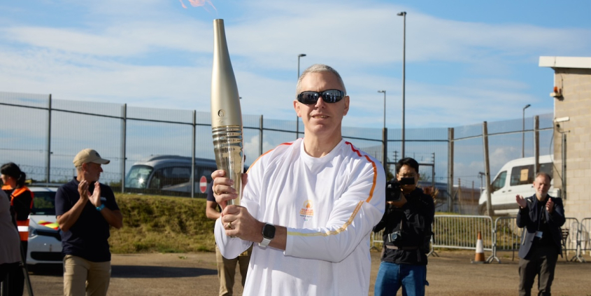 Former Paralympic Gold medallist Ian Rose with the 2024 Paralympic Games Torch